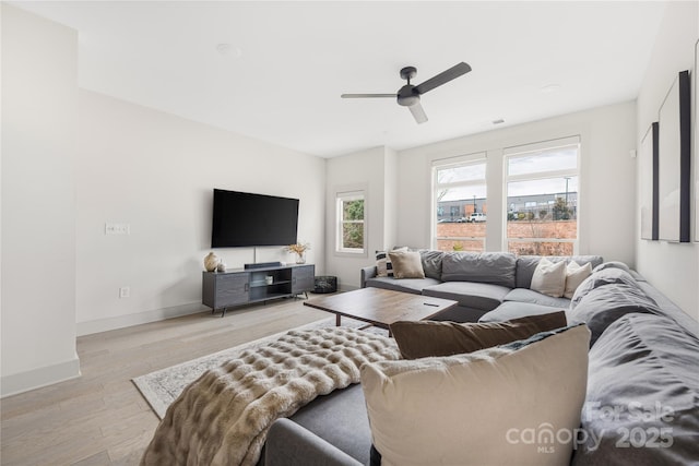 living room with ceiling fan and light hardwood / wood-style floors