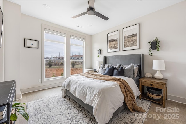 bedroom with ceiling fan and light wood-type flooring