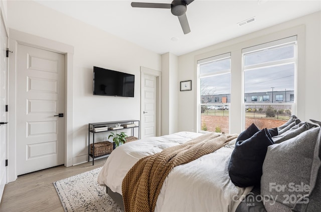 bedroom featuring light hardwood / wood-style flooring and ceiling fan