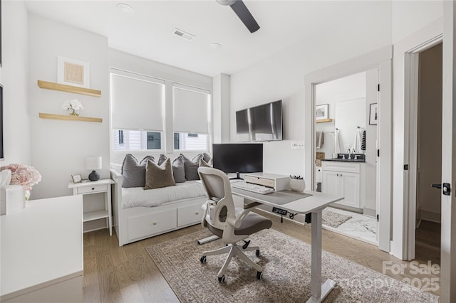 office featuring hardwood / wood-style floors and ceiling fan