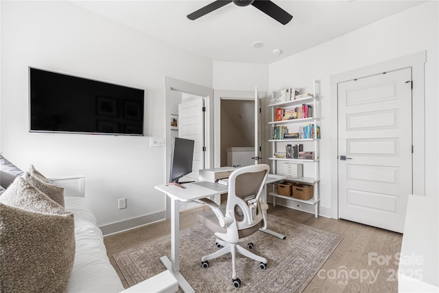 office space featuring light hardwood / wood-style floors and ceiling fan