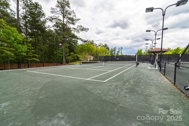 view of sport court featuring fence