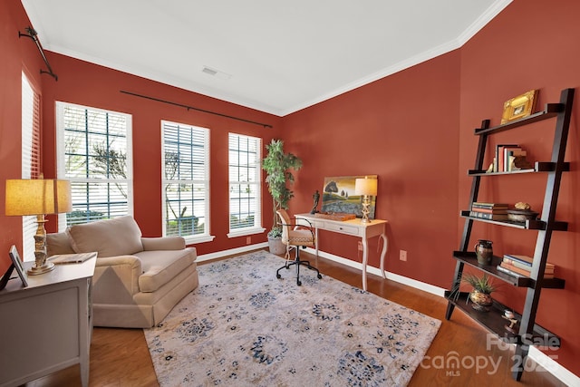 office area with visible vents, ornamental molding, baseboards, and wood finished floors