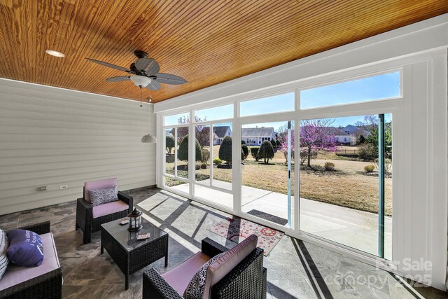 sunroom / solarium with an outdoor living space and ceiling fan