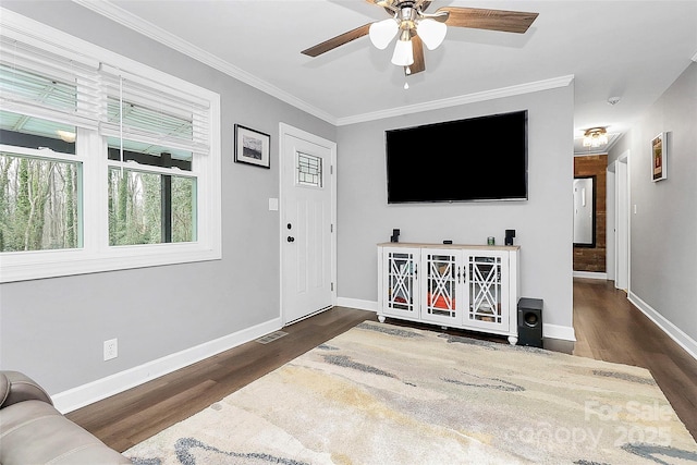 living room featuring crown molding, dark wood-type flooring, and ceiling fan