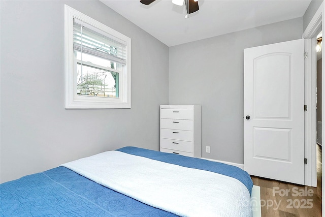 bedroom with ceiling fan and dark hardwood / wood-style floors