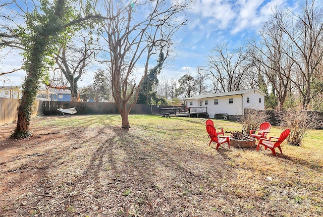 view of yard featuring a wooden deck and an outdoor fire pit