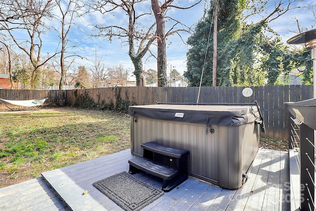 wooden deck with a hot tub