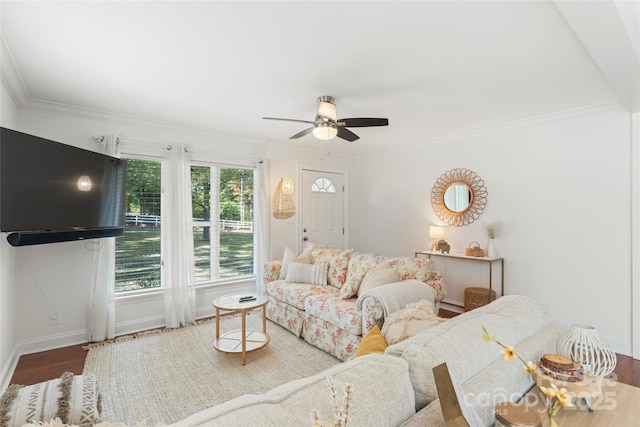 living room with baseboards, wood finished floors, a ceiling fan, and crown molding