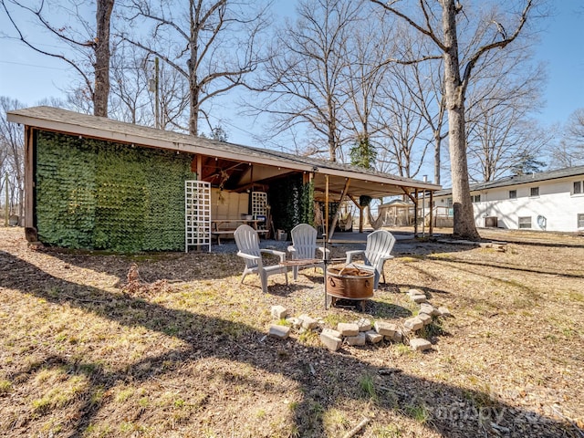 rear view of house featuring a fire pit