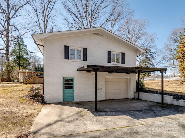 view of front facade featuring a garage, brick siding, and driveway