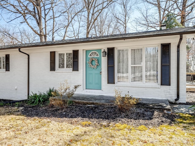 property entrance featuring brick siding