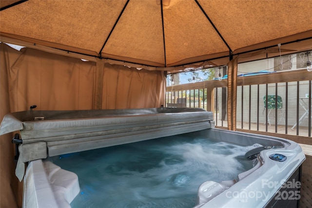 view of swimming pool with a gazebo and a hot tub