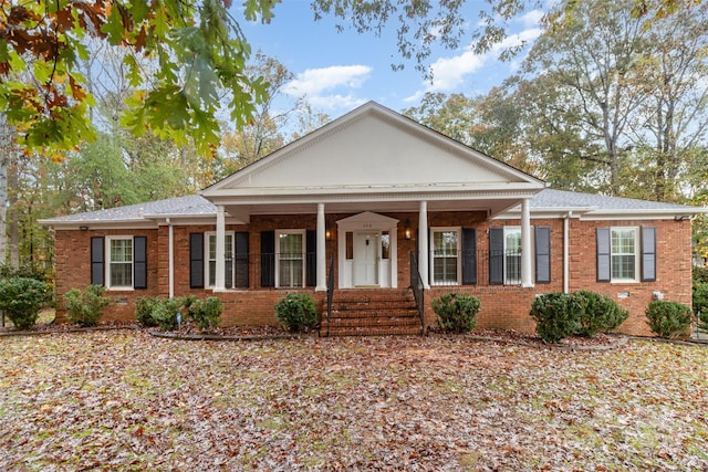 view of front facade with a porch and brick siding