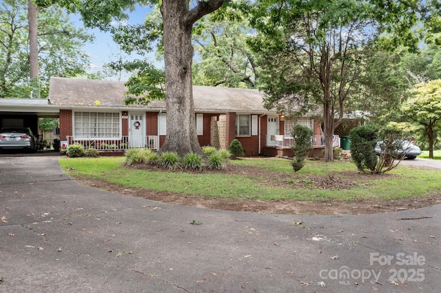 single story home with a carport and covered porch