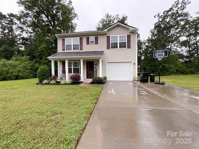 view of front facade featuring a garage, a front yard, and a porch