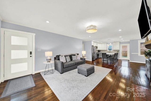 living room with crown molding and dark hardwood / wood-style floors