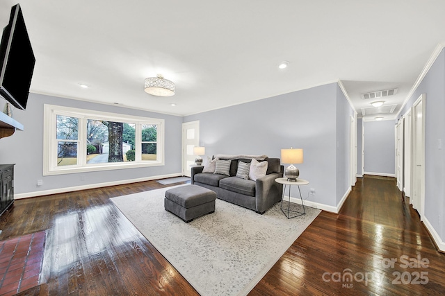 living room with crown molding and dark wood-type flooring