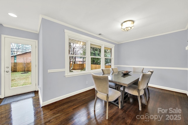 dining room featuring crown molding and dark hardwood / wood-style flooring