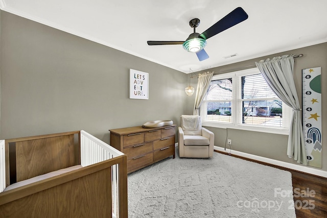 bedroom with ornamental molding and ceiling fan