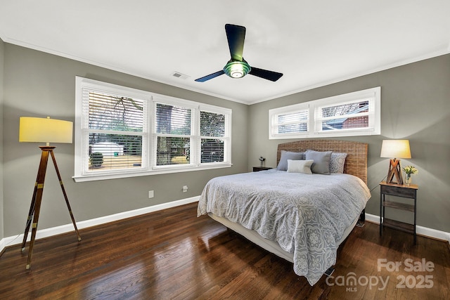 bedroom with ornamental molding, dark hardwood / wood-style floors, and ceiling fan