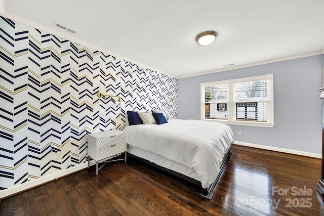 bedroom featuring crown molding and dark hardwood / wood-style floors