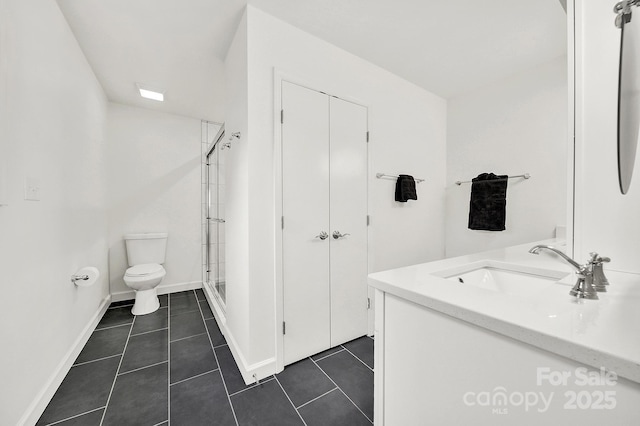 bathroom with tile patterned flooring, vanity, toilet, and an enclosed shower