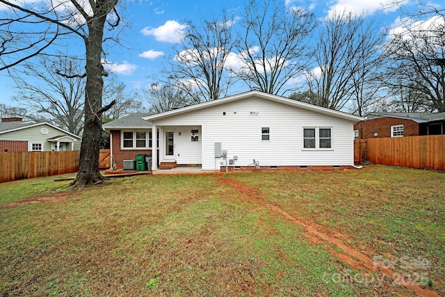 back of house with a lawn