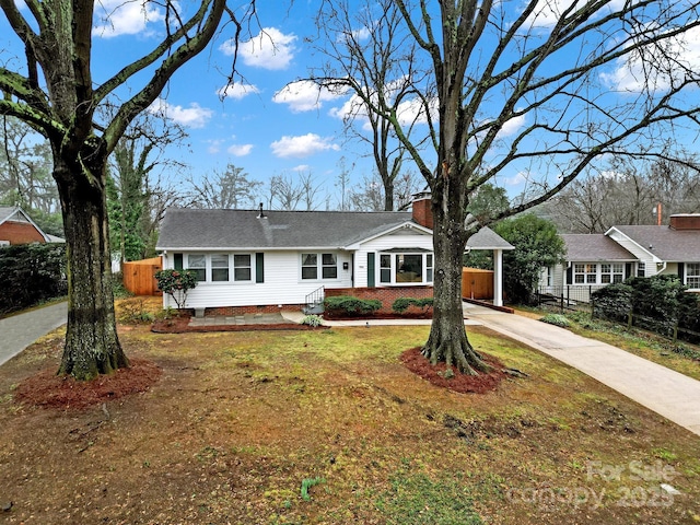 ranch-style home with a front lawn