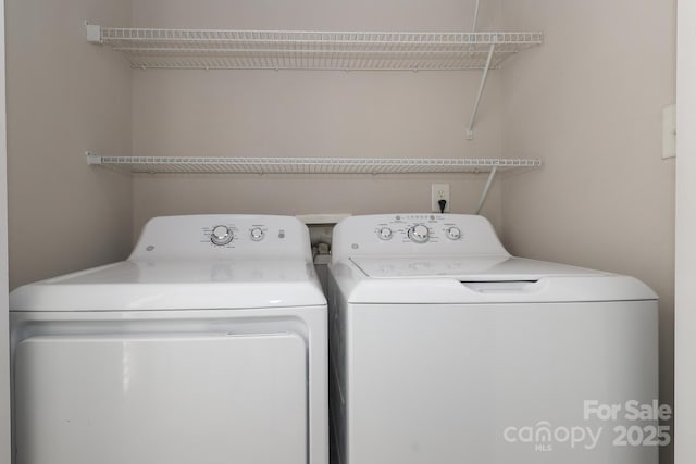 clothes washing area with washing machine and dryer