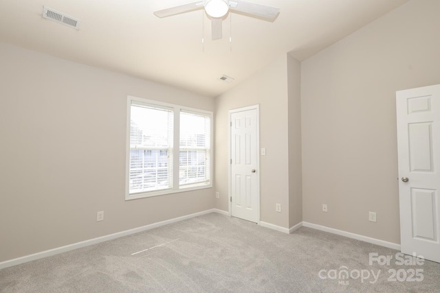 unfurnished bedroom with light carpet, vaulted ceiling, and ceiling fan