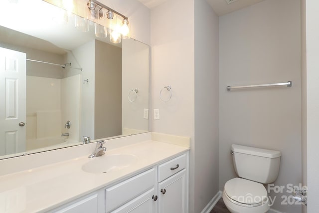 full bathroom with toilet, vanity, and shower / washtub combination