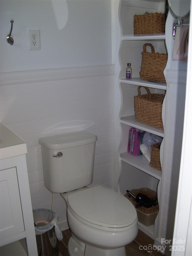 bathroom featuring hardwood / wood-style flooring, vanity, and toilet