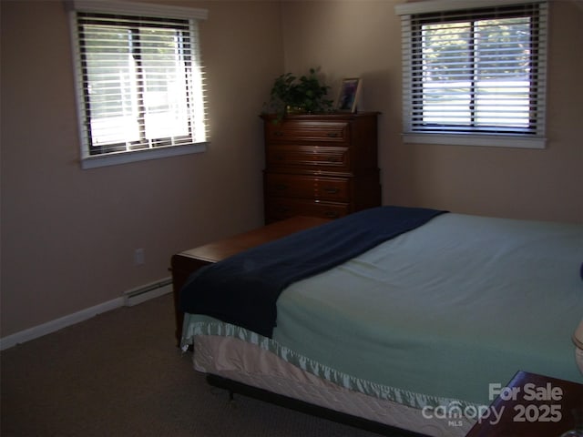 carpeted bedroom with a baseboard heating unit