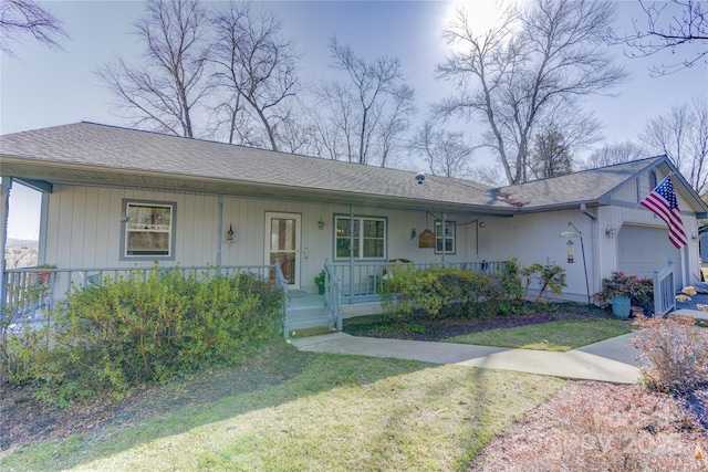 ranch-style home with a porch, a garage, and a front yard