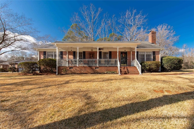 view of front of house with a front yard and a porch