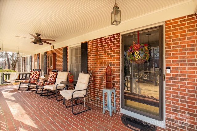 entrance to property featuring a porch and ceiling fan