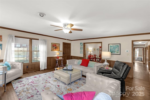 living room featuring hardwood / wood-style flooring, ornamental molding, and ceiling fan