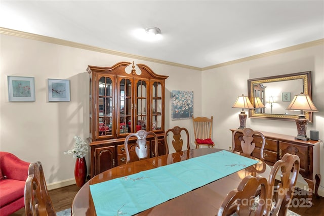 dining room featuring dark wood-type flooring and crown molding