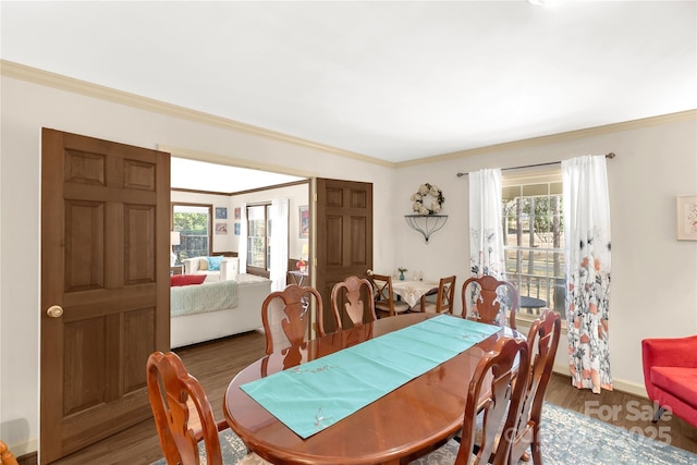 dining area with hardwood / wood-style floors and ornamental molding