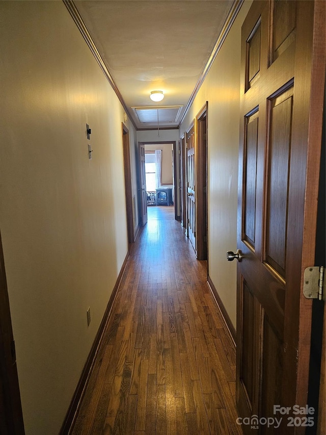 corridor featuring dark hardwood / wood-style flooring and crown molding