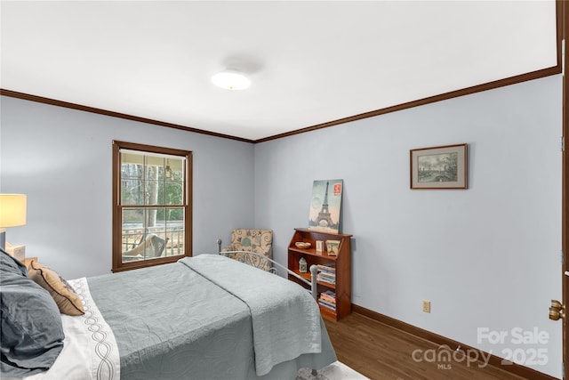 bedroom featuring dark wood-type flooring and crown molding