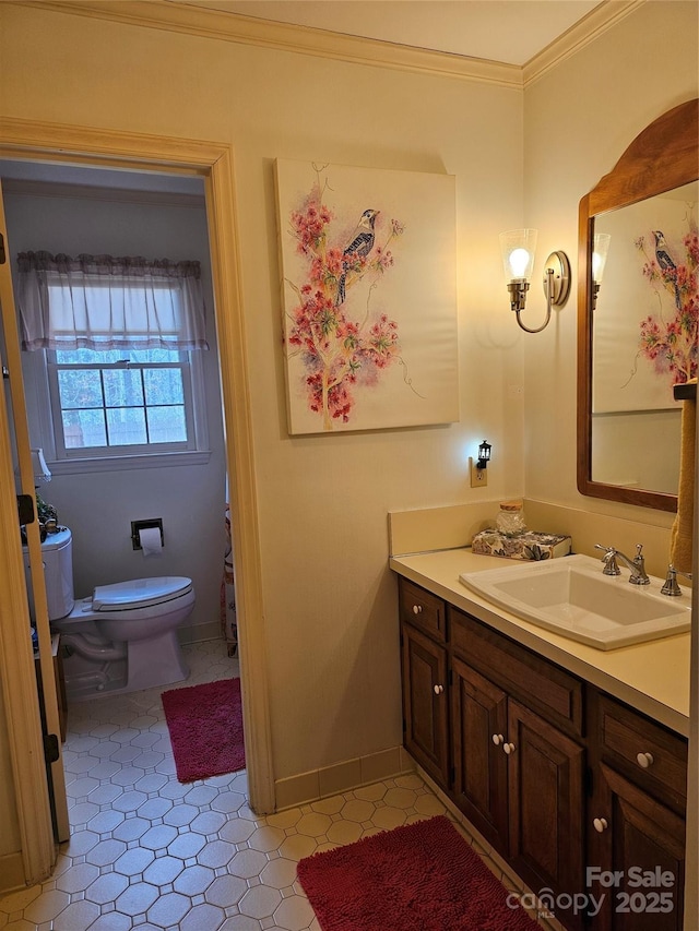 bathroom featuring vanity, ornamental molding, and toilet