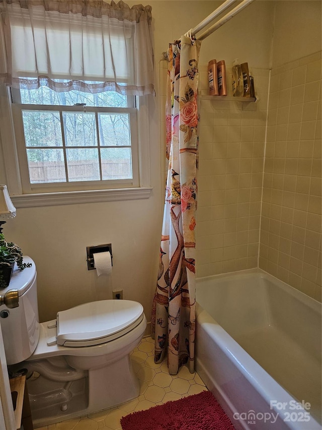 bathroom with toilet and shower / tub combo