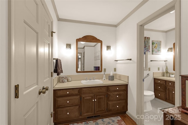 bathroom featuring ornamental molding, toilet, and vanity