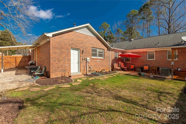 back of property with cooling unit and a lawn