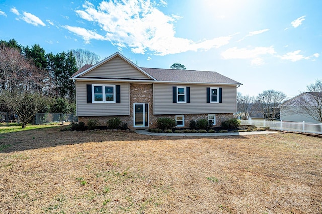 split foyer home with a front lawn