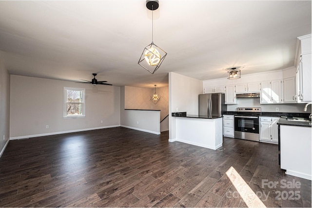 kitchen with appliances with stainless steel finishes, dark hardwood / wood-style floors, pendant lighting, sink, and white cabinets