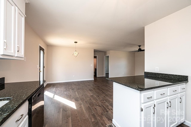 kitchen with dishwasher, white cabinets, dark hardwood / wood-style flooring, decorative light fixtures, and dark stone counters