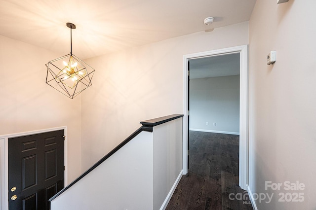 interior space featuring hardwood / wood-style flooring and an inviting chandelier